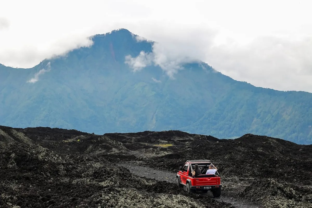 Jeep driving on Mount Batur black sand
